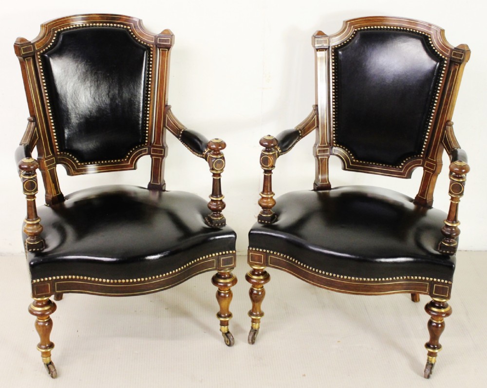 pair of brass inlaid leather upholstered armchairs