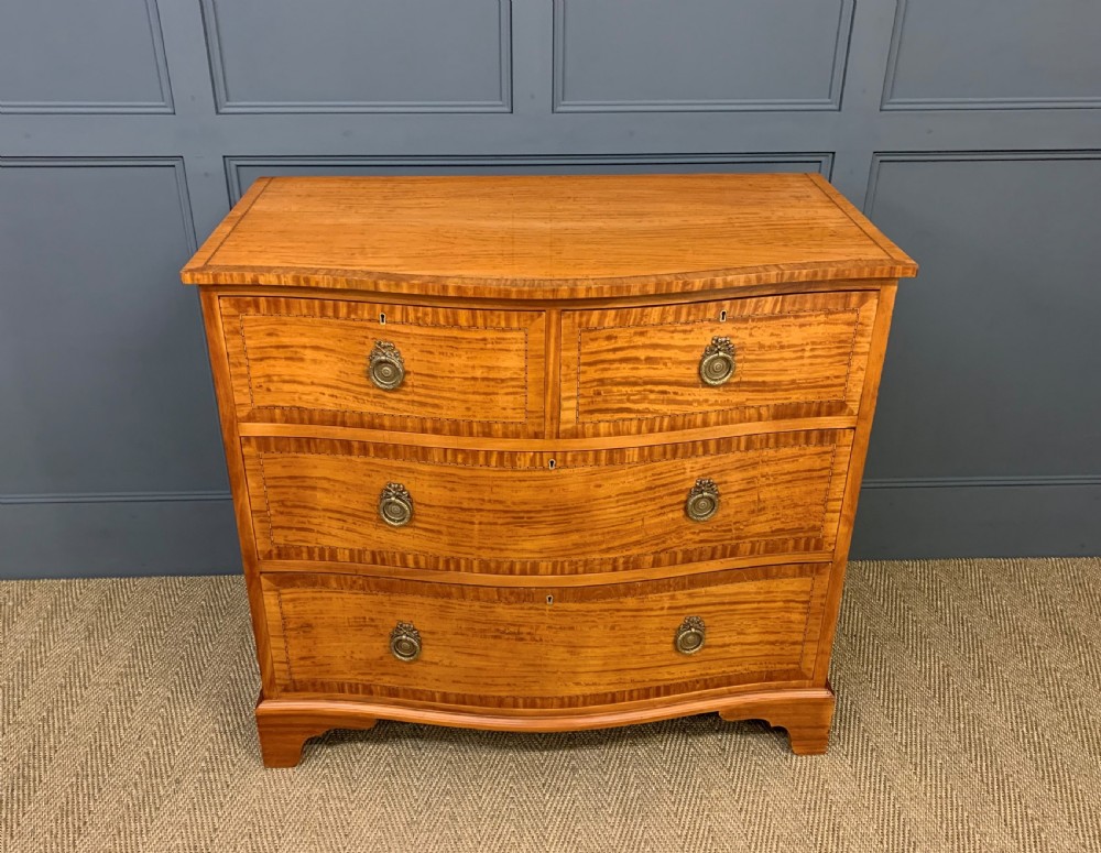 inlaid satinwood serpentine fronted chest of drawers