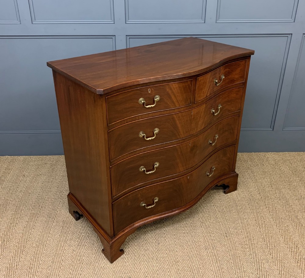 serpentine mahogany chest of drawers