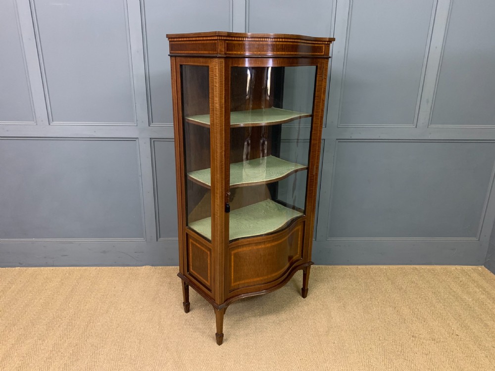 serpentine inlaid mahogany display cabinet