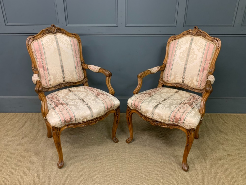 pair of french carved walnut armchairs